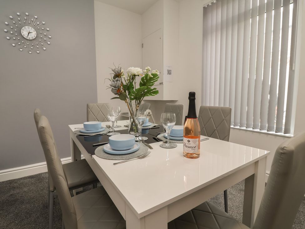 A dining room with a table set for a meal at Lunt Road in Bootle