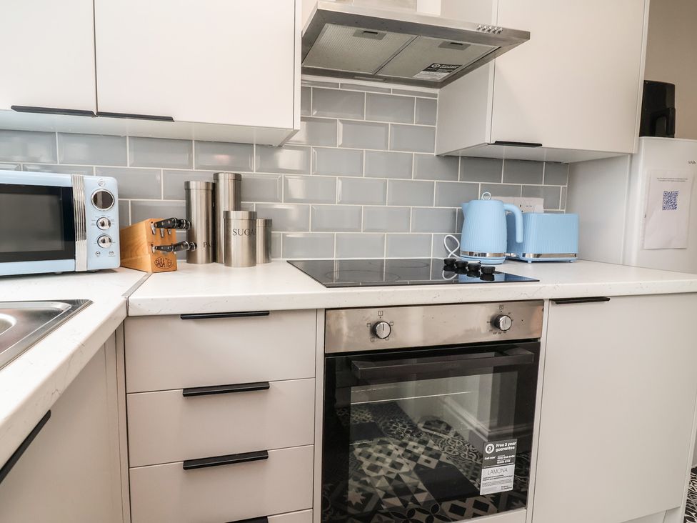 A kitchen featuring a microwave, kettle, and oven at Lunt Road, Bootle