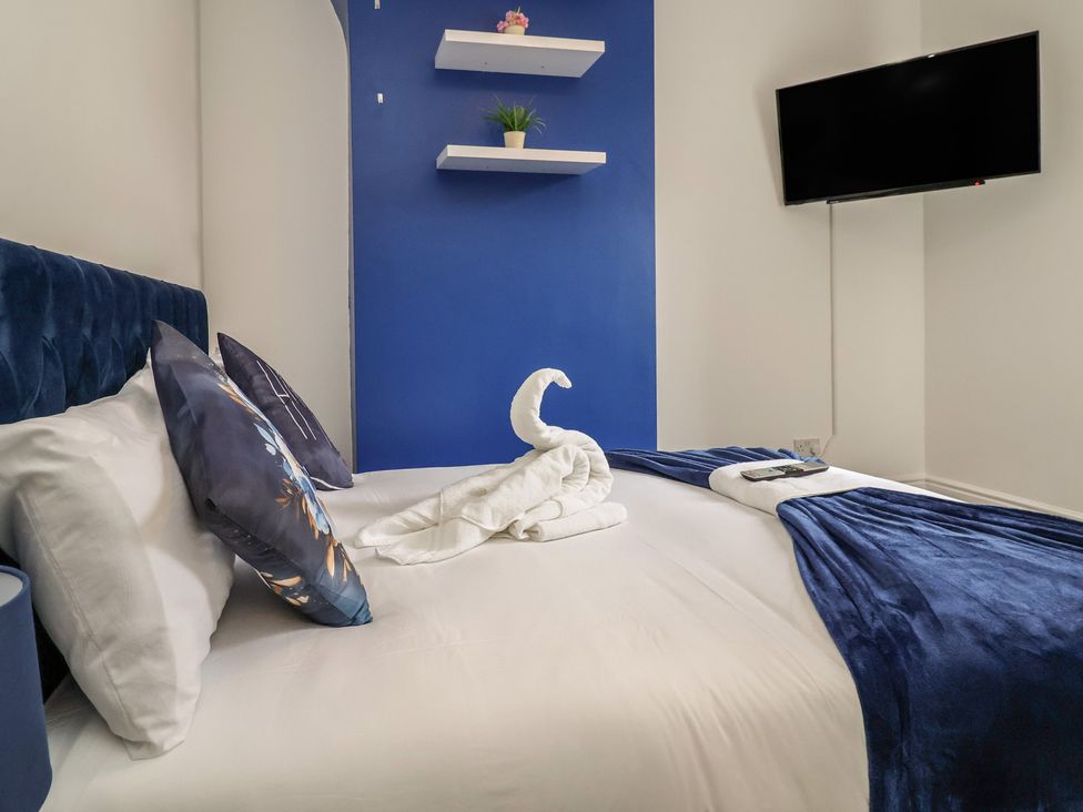 A bedroom with a bed and television at Lunt Road in Bootle