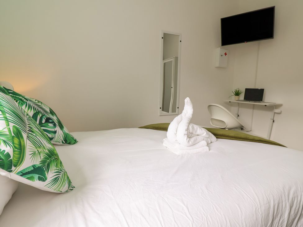A bedroom with a bed and desk at Lunt Road in Bootle