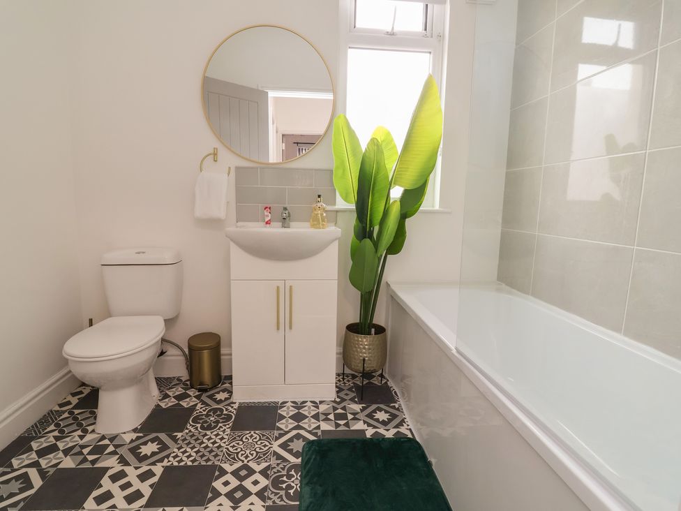 A bathroom with a toilet, sink, and bathtub at Lunt Road in Bootle