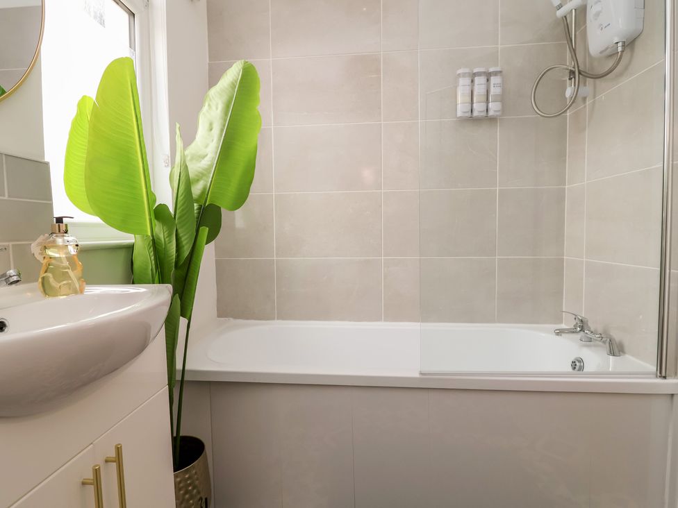 A bathroom with a bathtub and sink at Lunt Road in Bootle
