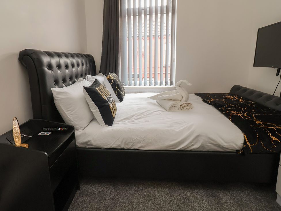 A bedroom with a bed and television at Lunt Road in Bootle