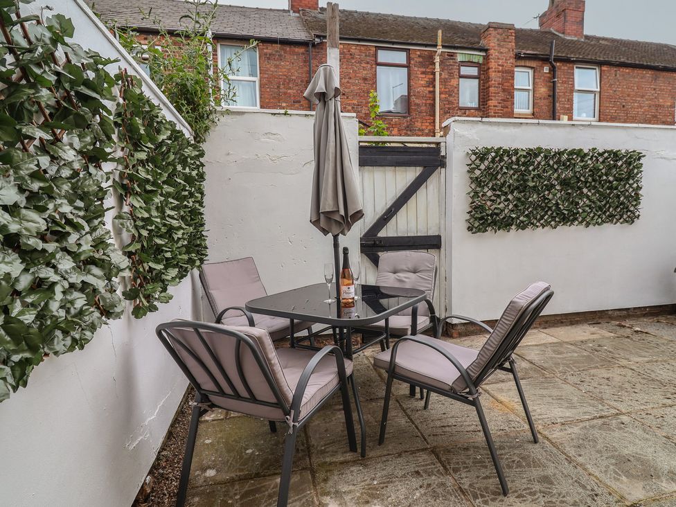 A garden with a table and chairs at Lunt Road in Bootle