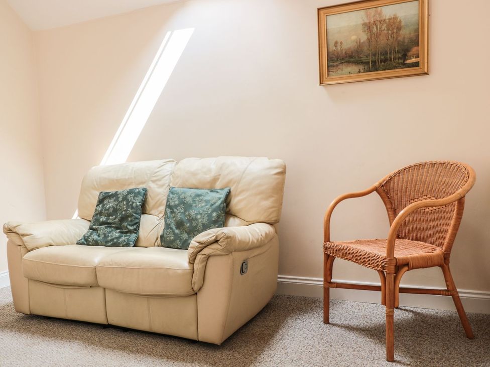 A living room with a sofa and a chair at The Hop Kiln in Tenbury Wells
