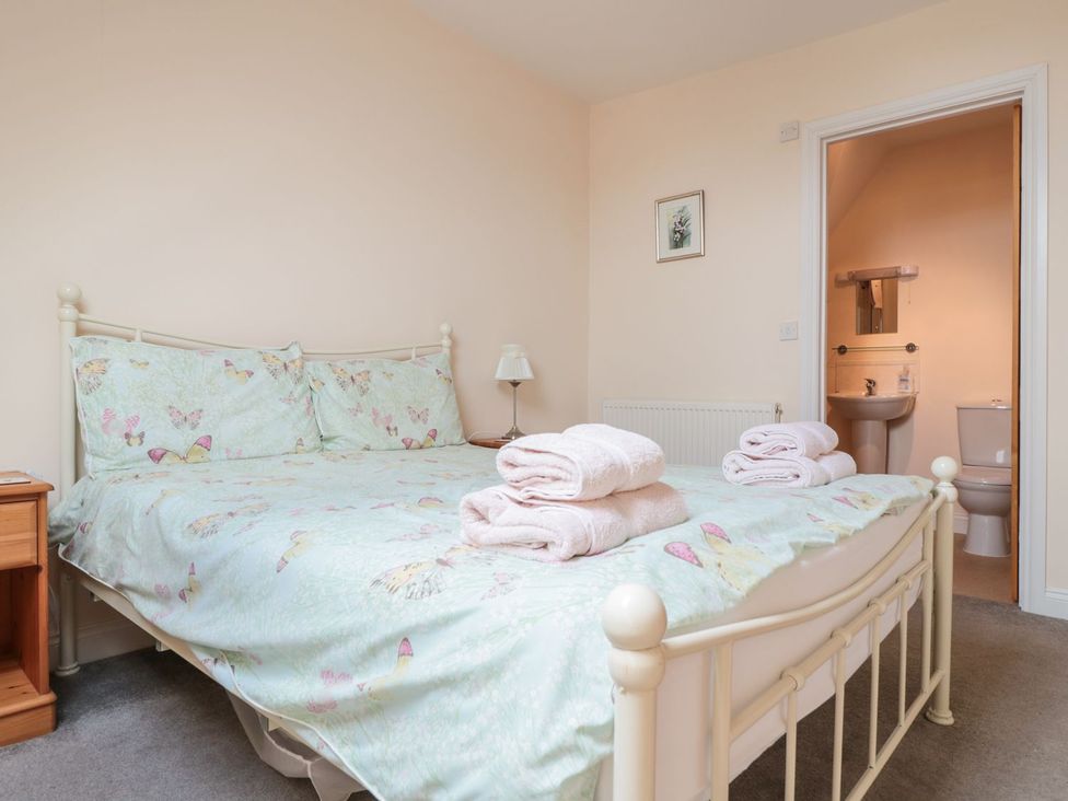 A bedroom with a bed and bathroom access at The Hop Kiln in Tenbury Wells