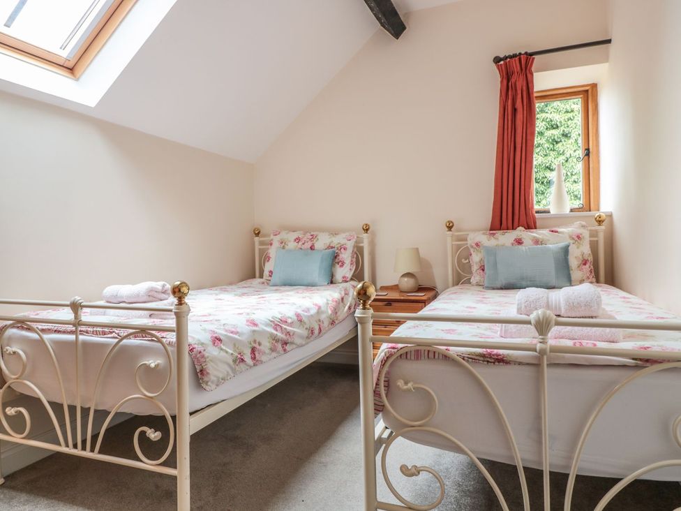 A bedroom with two beds and a window at The Hop Kiln in Tenbury Wells