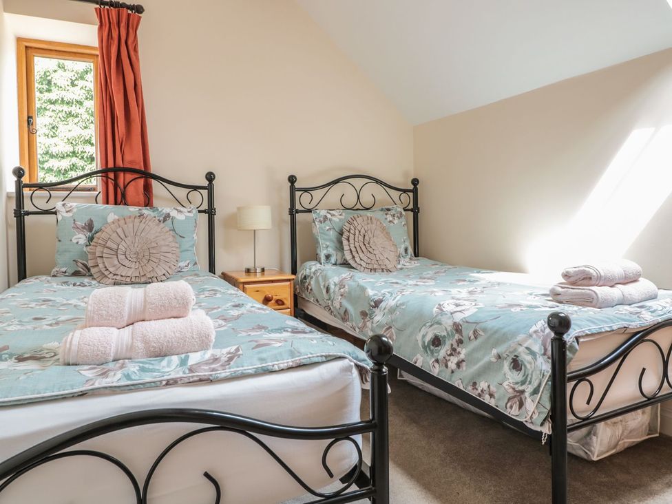 Two single beds with towels on top at The Hop Kiln in Tenbury Wells