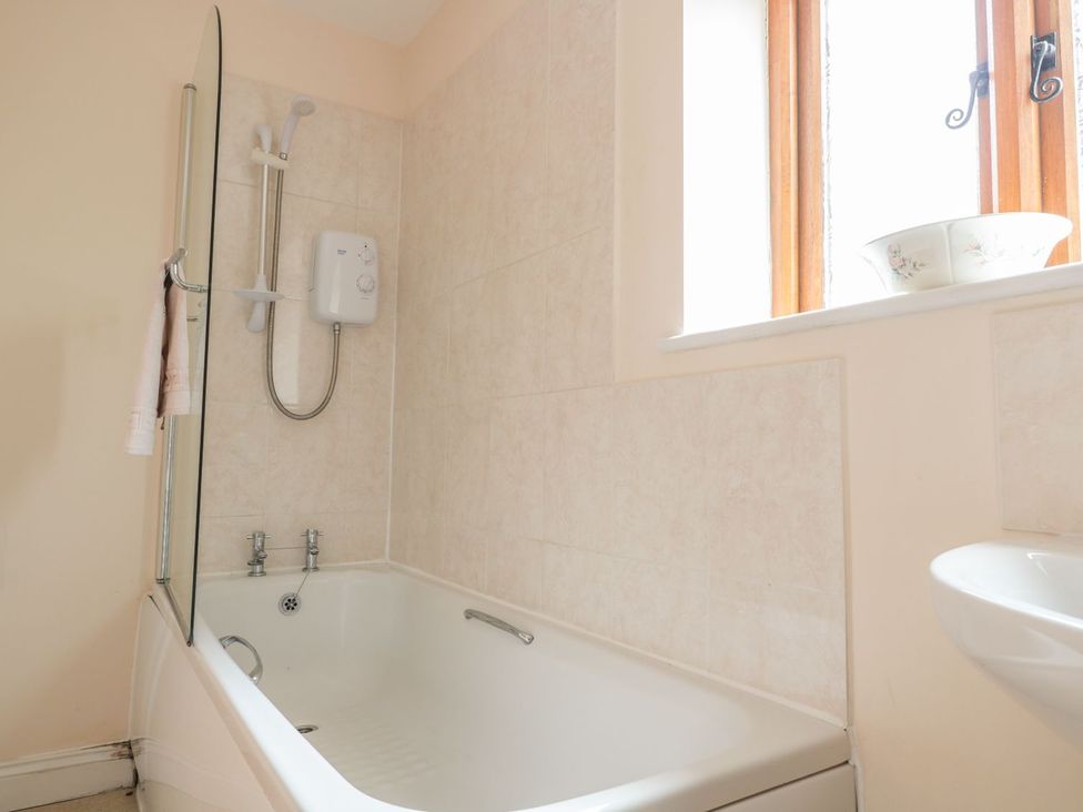 A bathroom with a bathtub and shower at The Hop Kiln in Tenbury Wells