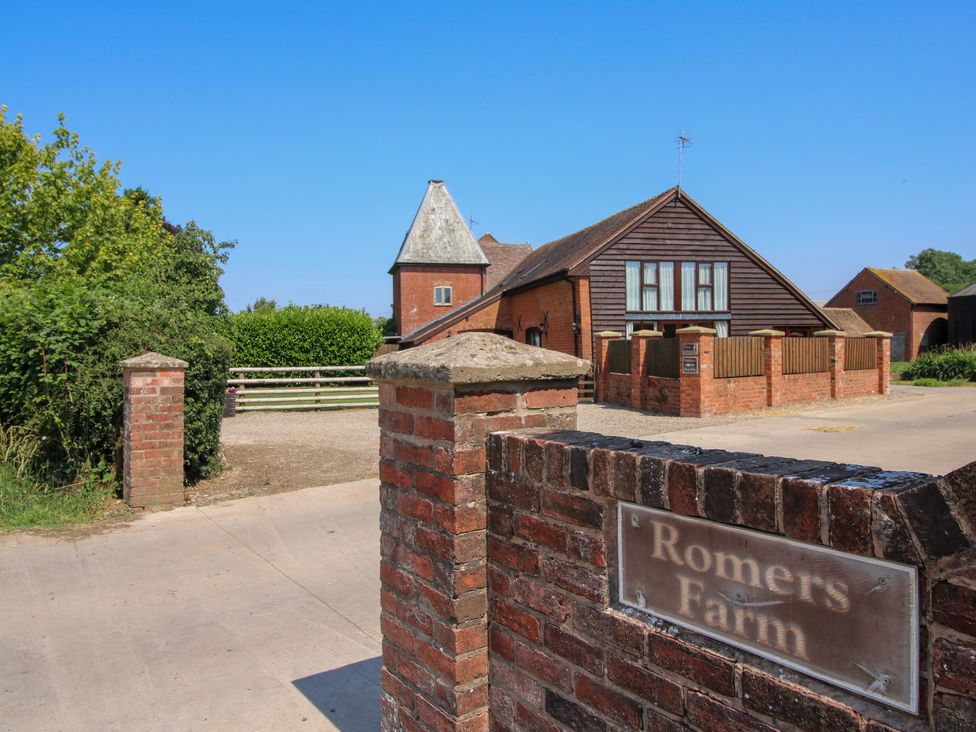 A farm entrance with a house and gate at Romers Farm in Tenbury Wells