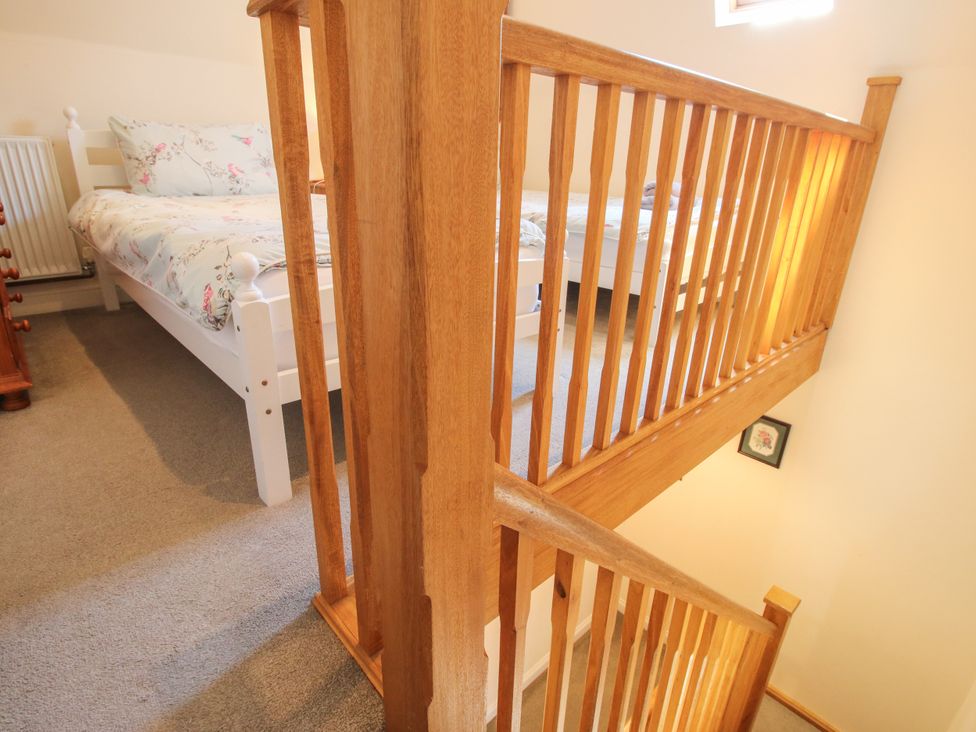 A bedroom with a bed and staircase at The Hop Kiln in Tenbury Wells