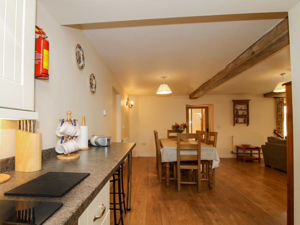 A kitchen with dining area and features including shelves at The Hop Kiln in Tenbury Wells