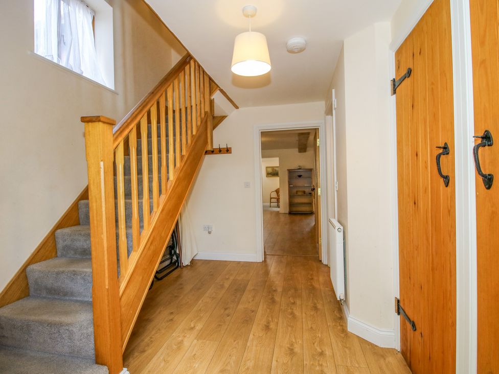 A hallway with stairs and a front door at The Hop Kiln in Tenbury Wells