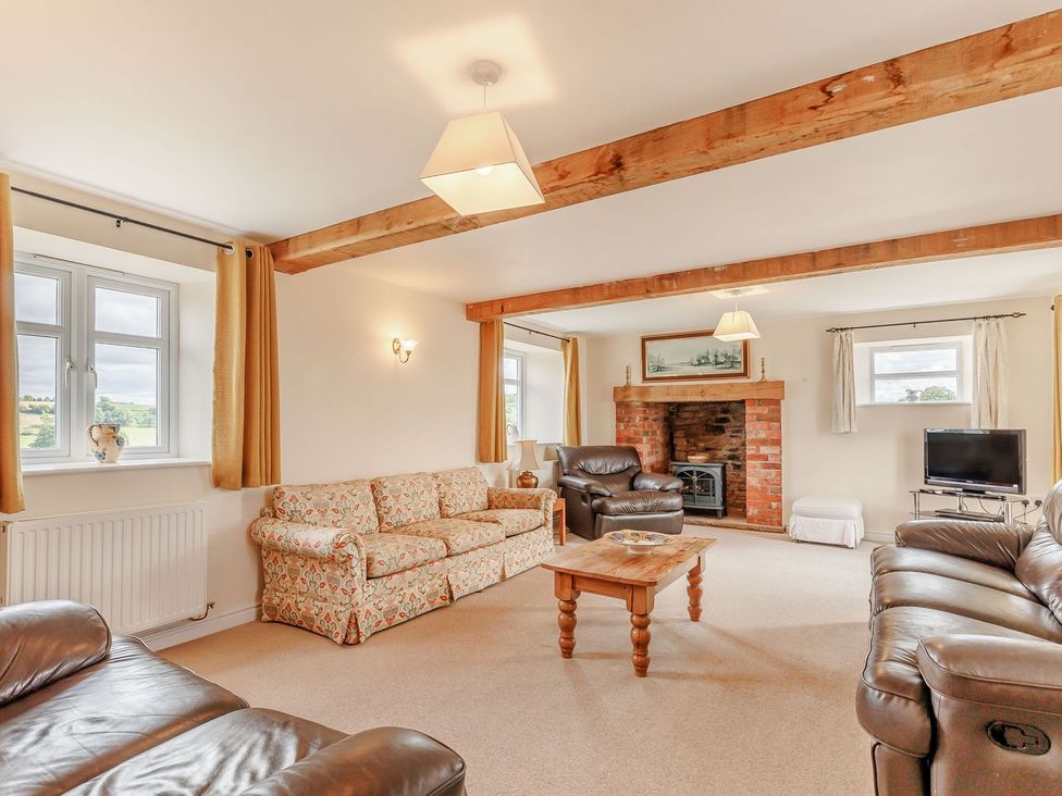 A living room with sofa and television at Wood Cottage Tenbury Wells