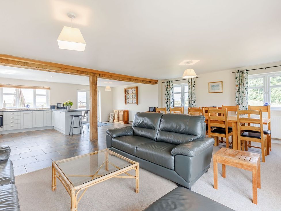 A living room with a sofa and coffee table at Wood Cottage in Tenbury Wells