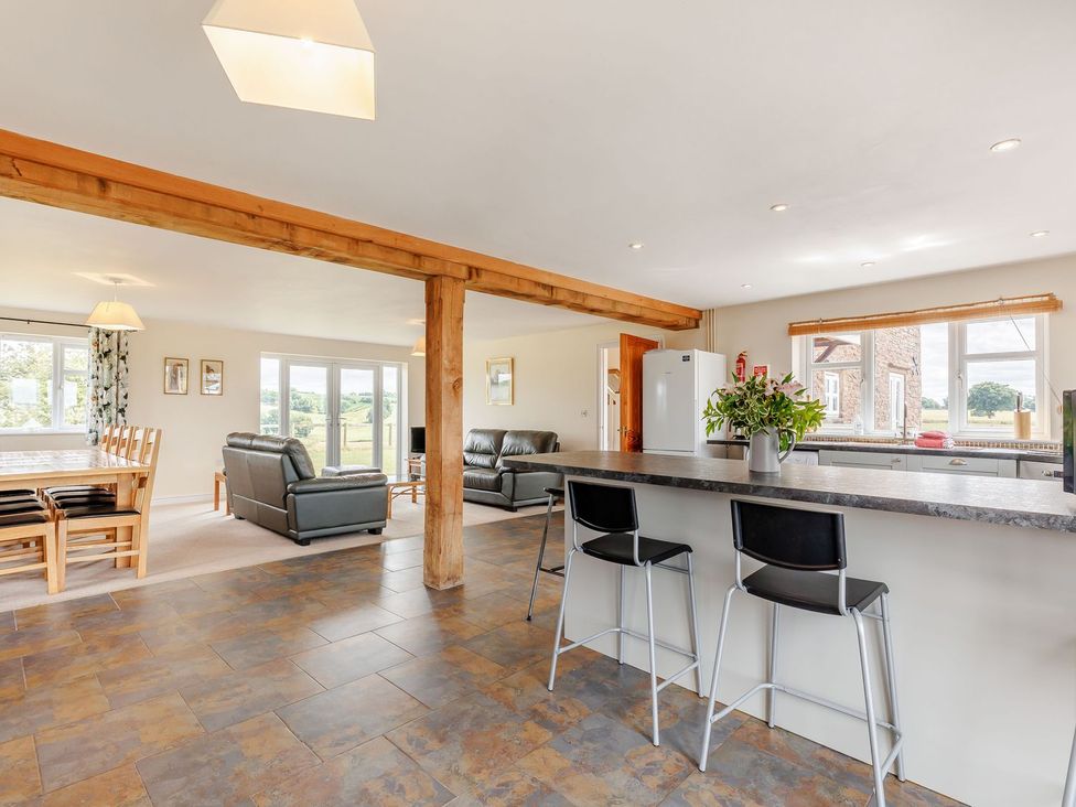 A kitchen with a dining area and seating at Wood Cottage in Tenbury Wells
