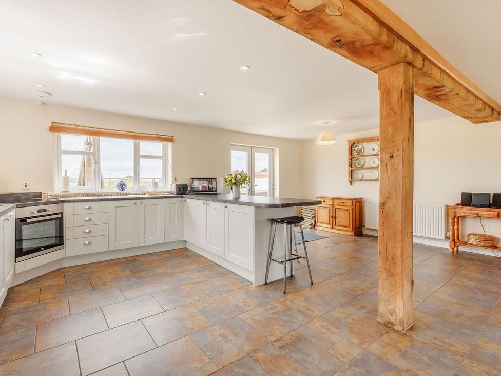 A kitchen with cabinets and a counter at Wood Cottage in Tenbury Wells