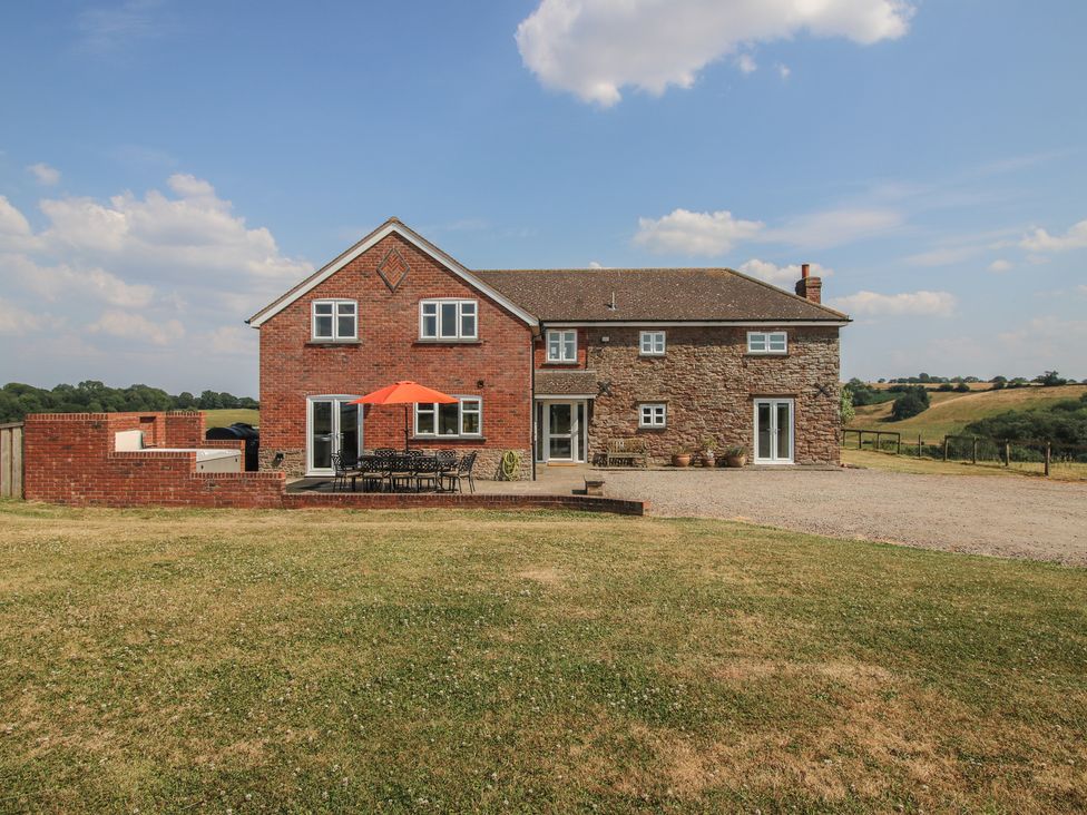 A house with a terrace and outdoor seating at Wood Cottage in Tenbury Wells