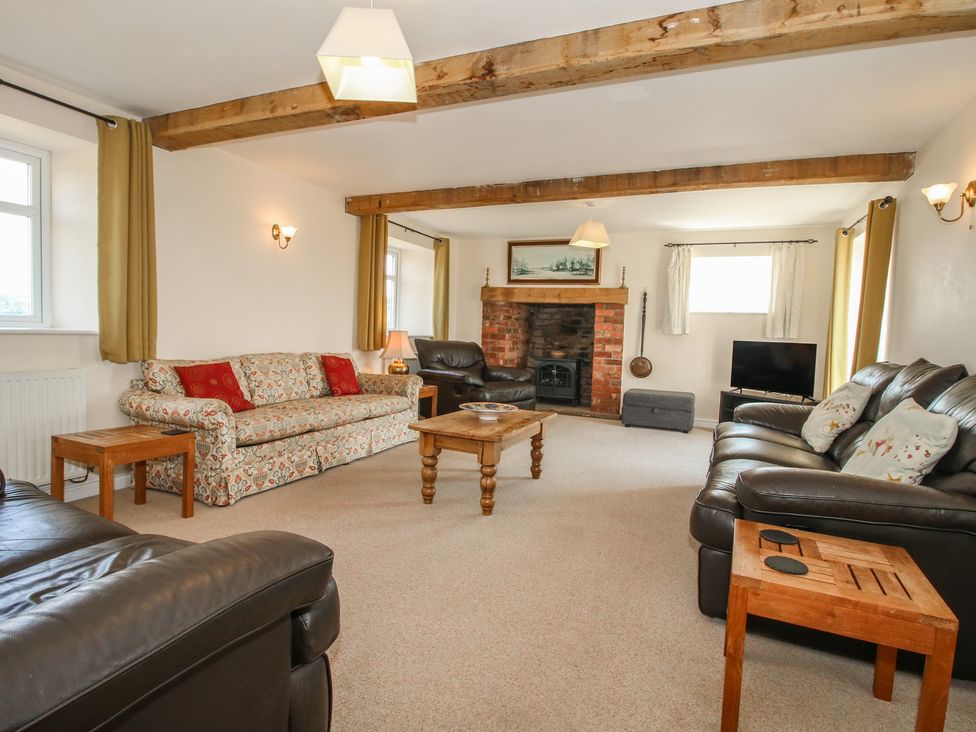 A living room with a sofa and coffee table at Wood Cottage Tenbury Wells