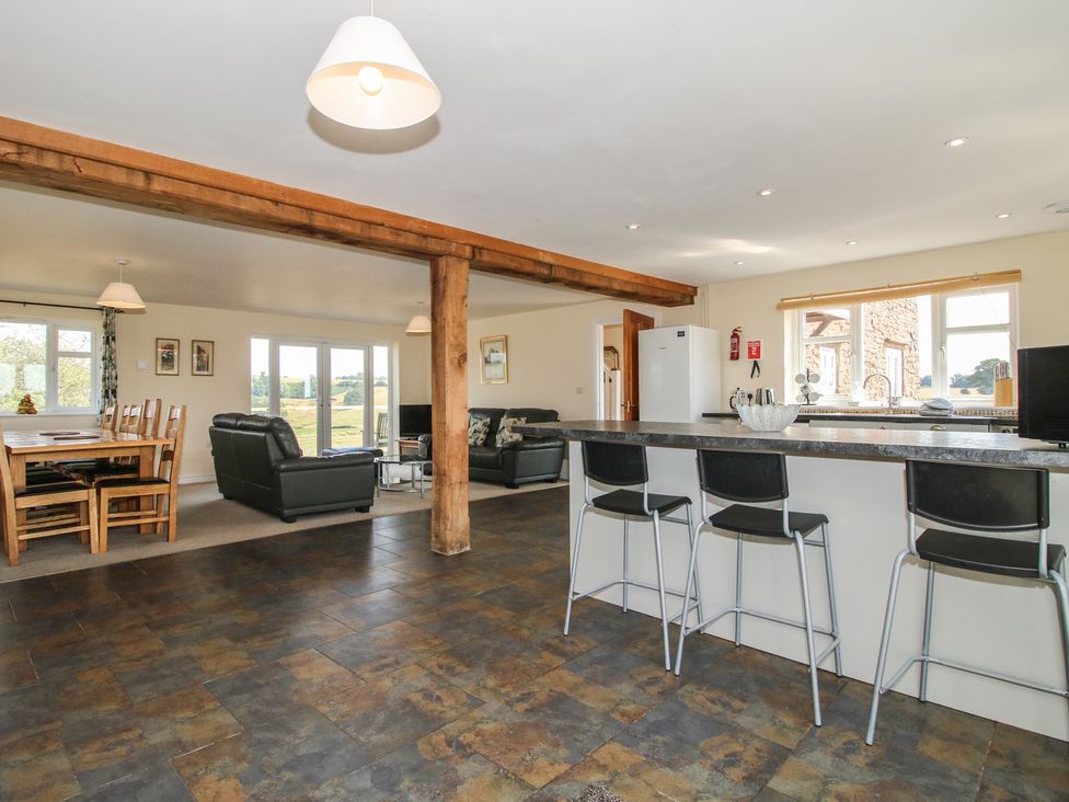 A kitchen with dining area and seating at Wood Cottage in Tenbury Wells