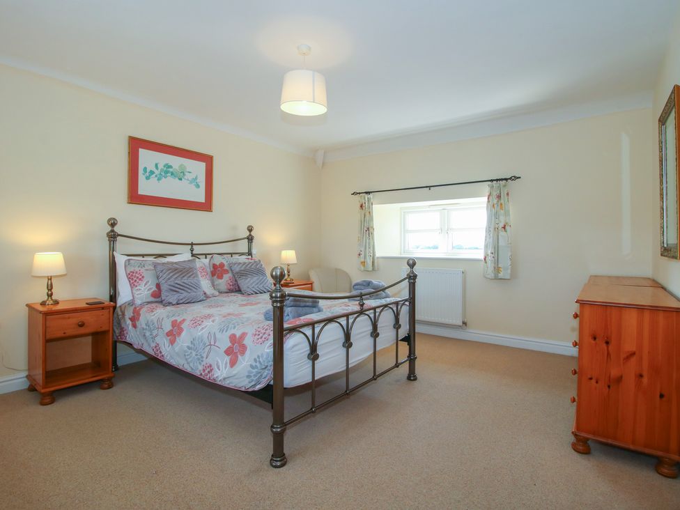 A bedroom with a bed and bedside tables at Wood Cottage in Tenbury Wells