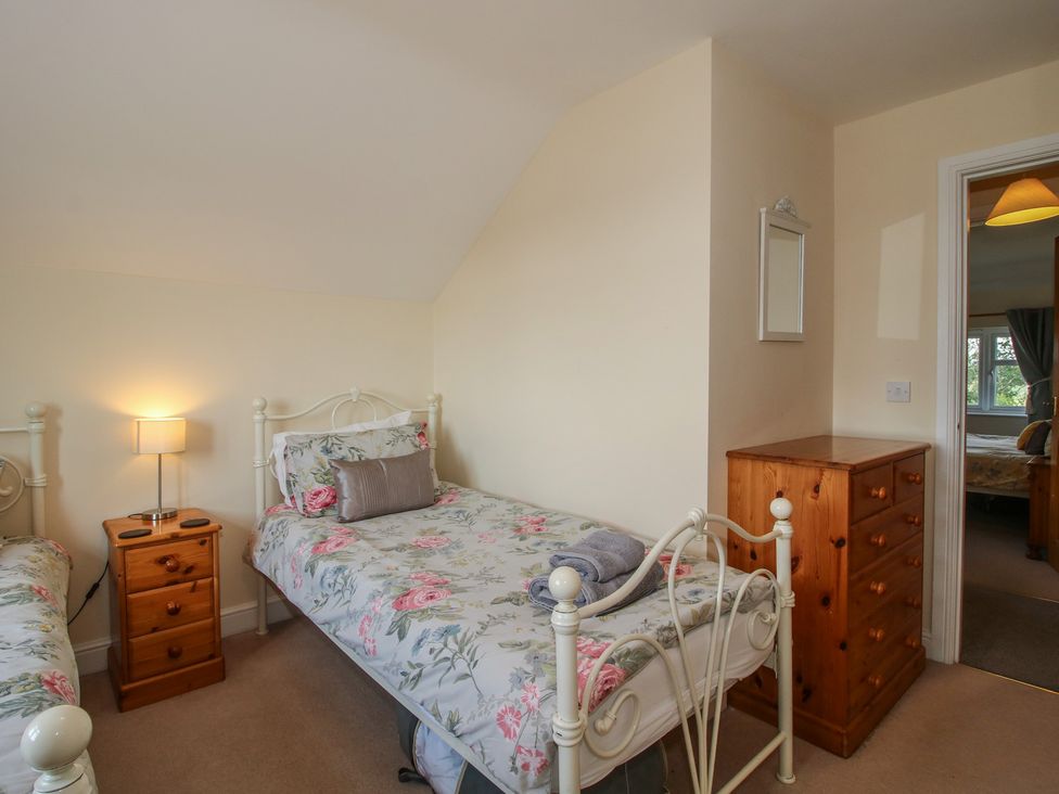 A bedroom with two beds and a chest of drawers at Wood Cottage in Tenbury Wells
