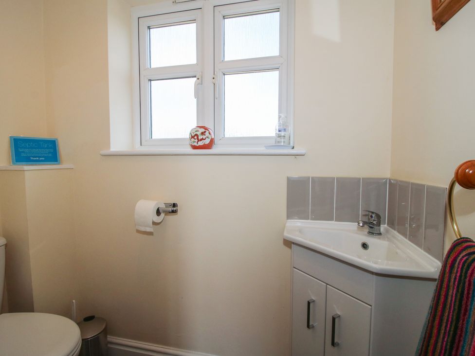 A bathroom with a toilet and sink at Wood Cottage in Tenbury Wells