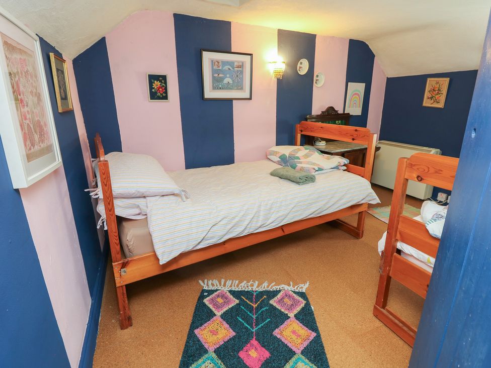 A bedroom with a bed and bunk bed at Dairy Cottage Whitwell near Niton