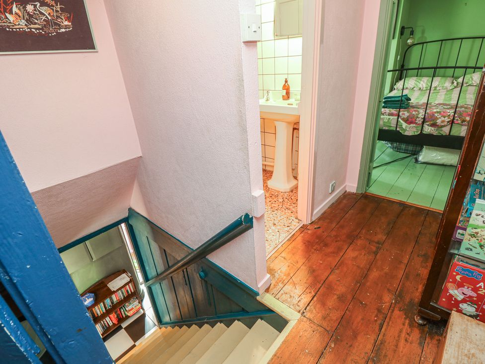A staircase leading to a restroom and a bedroom at Dairy Cottage Whitwell near Niton