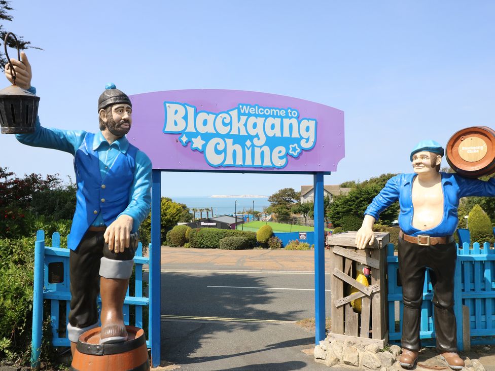 A welcome sign and statues at Blackgang Chine in Whitwell near Niton