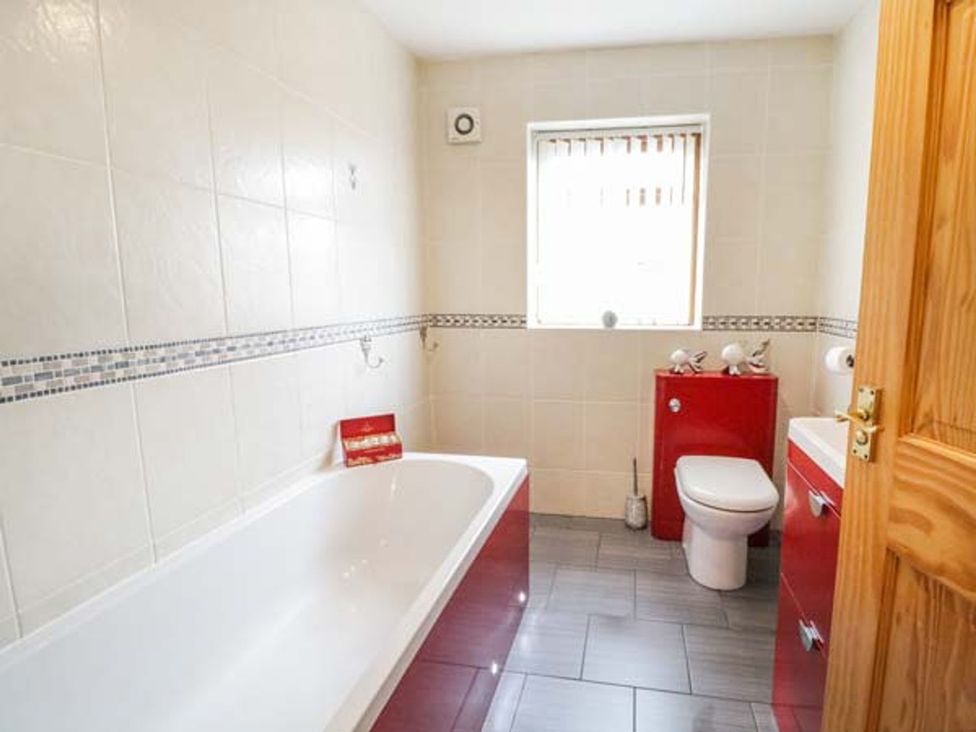 A bathroom with a bathtub and toilet at 1 The Old Smithy in Cemaes Bay