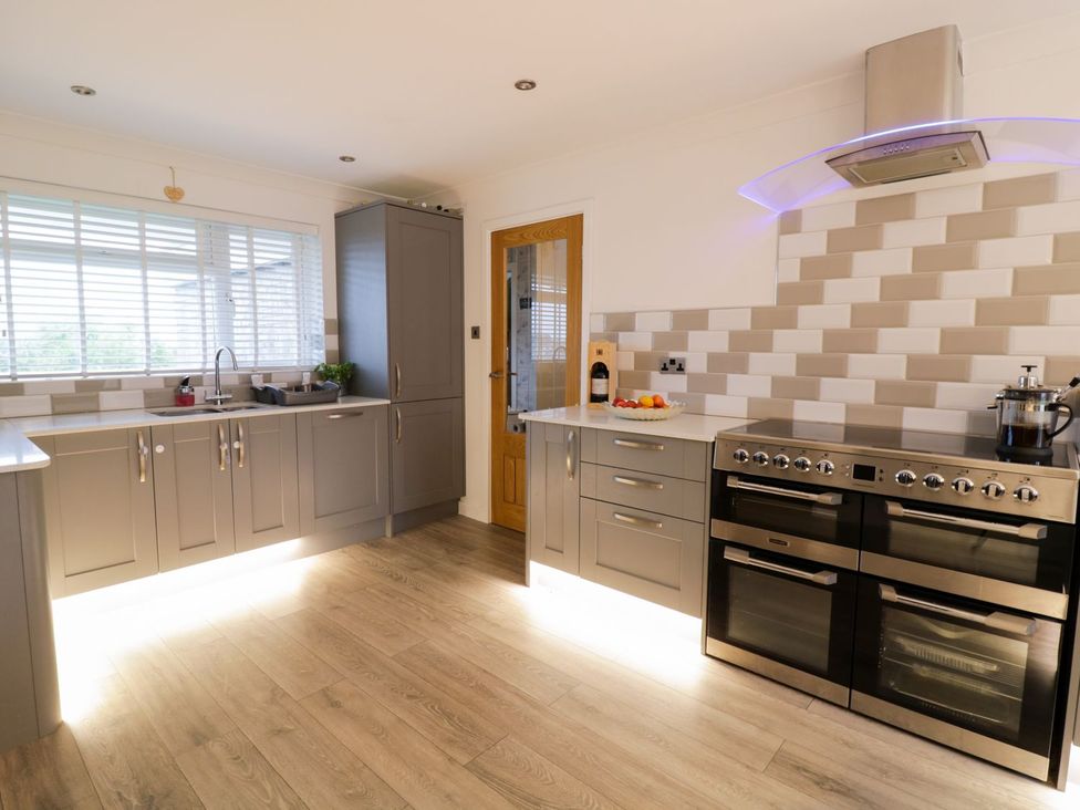 A kitchen with cabinets and a cooking range at Gwelfor, Cemaes Bay