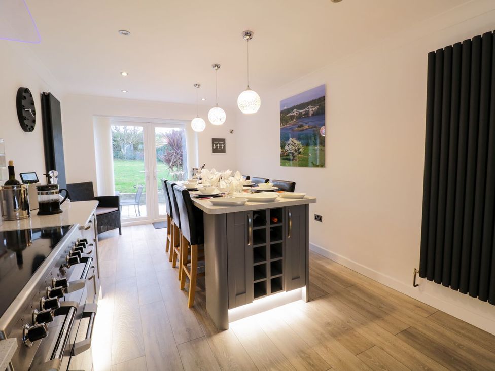 A kitchen with a table and chairs at Gwelfor in Cemaes Bay