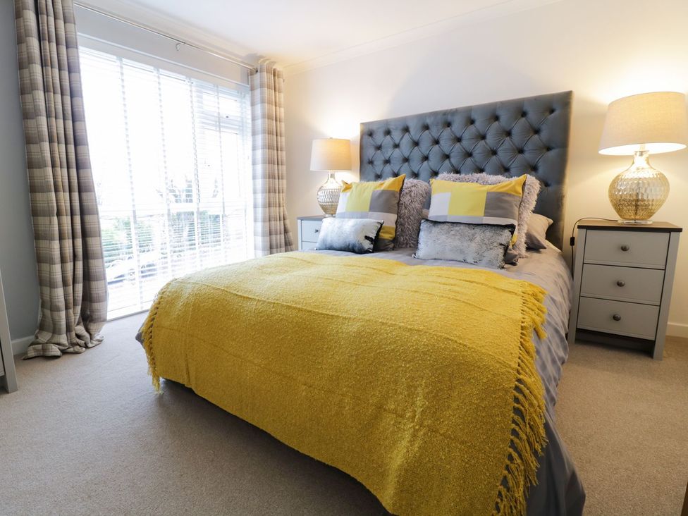 A bedroom with a bed and lamps at Gwelfor in Cemaes Bay