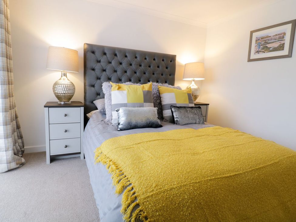 A bedroom with a bed and bedside tables at Gwelfor in Cemaes Bay