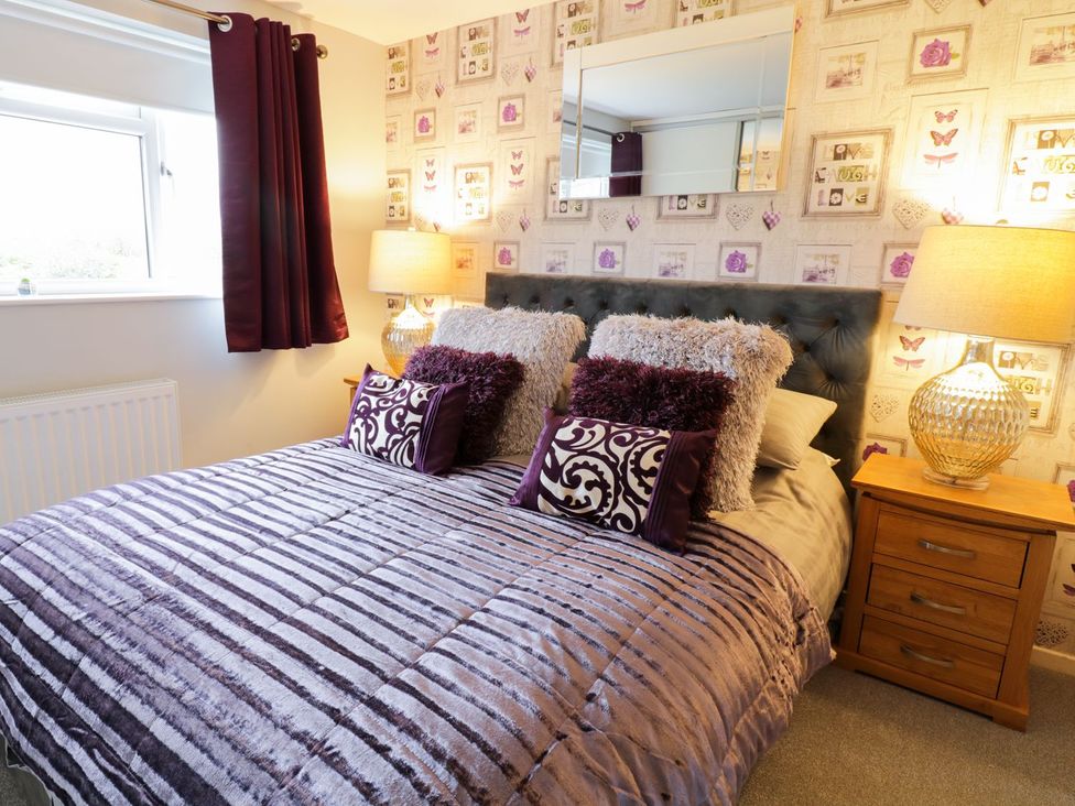 A bedroom with a bed and bedside table at Gwelfor in Cemaes Bay