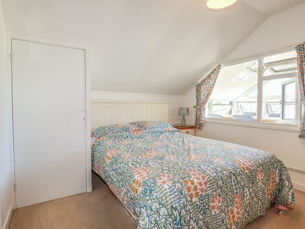 A bedroom with a double bed and bedside table at Coombe Lodge No 9 in Bude