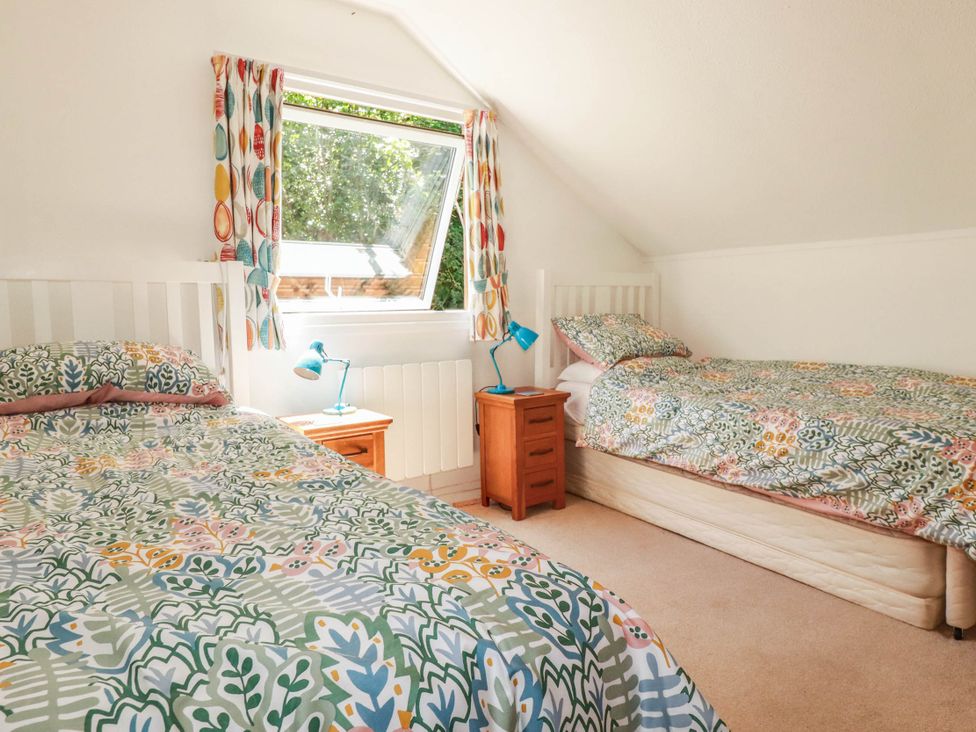 A bedroom with two beds and a window at Coombe Lodge No 9 in Bude
