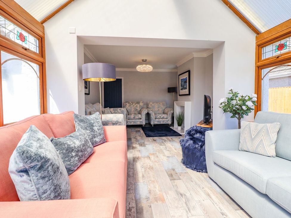 A living room with a sofa and television at Trefin in Cemaes Bay