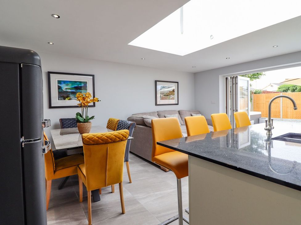 A kitchen with a table and chairs at Trefin in Cemaes Bay