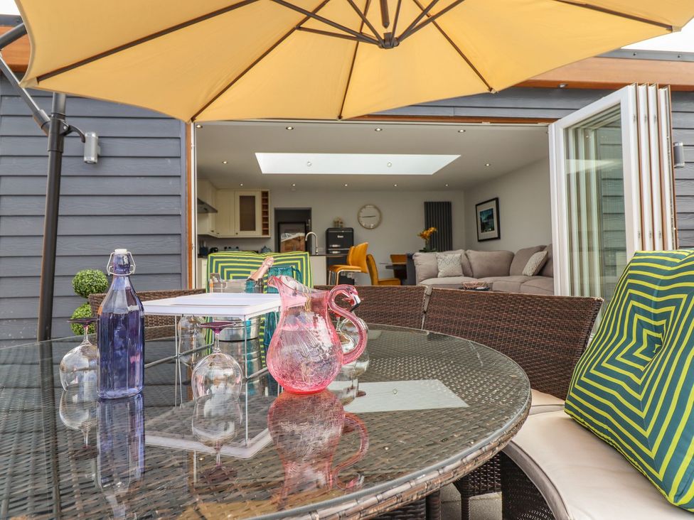 An outdoor seating area with a table and chairs at Trefin Cemaes Bay