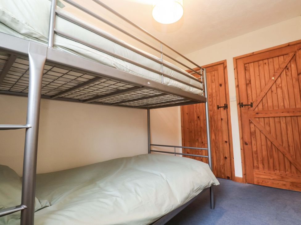 A bunk bed with two mattresses in a bedroom at Swallow Cottage Helston