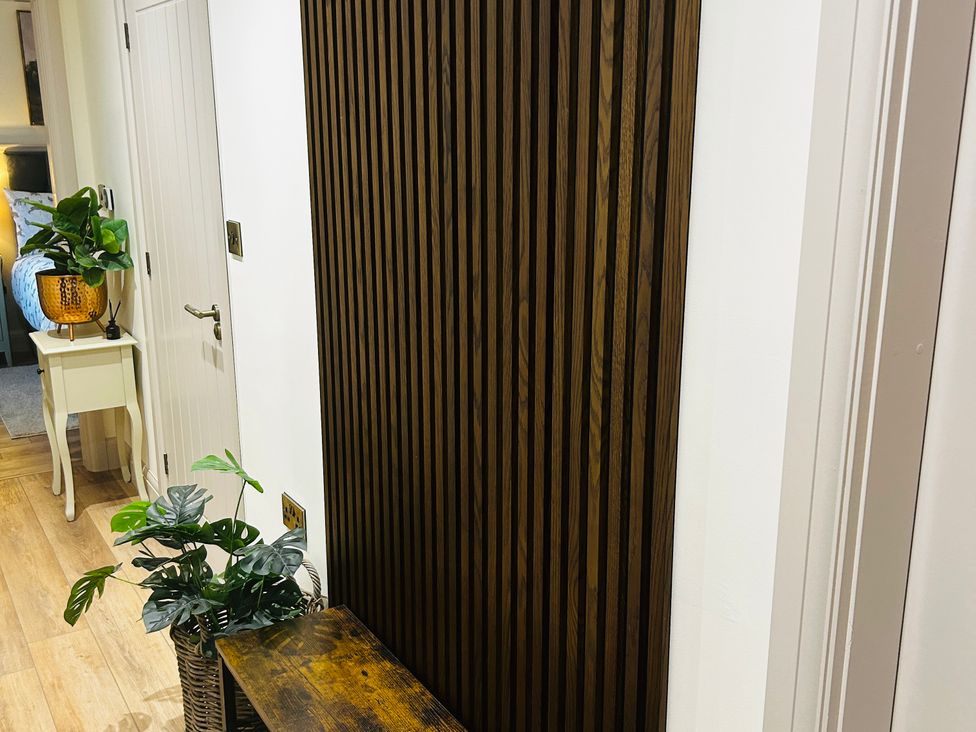 A hallway with a plant and table at Badger Cottage in Wold Newton