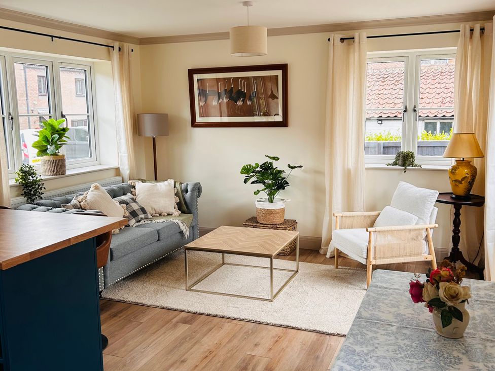 A living room with a sofa and coffee table at Badger Cottage in Wold Newton