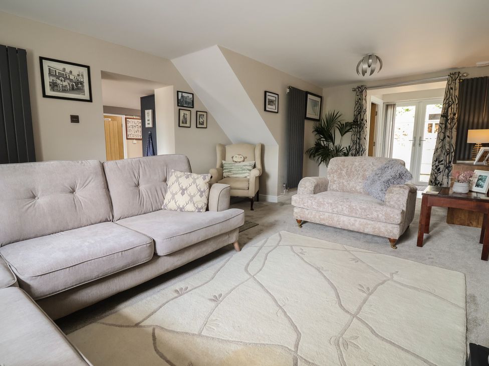 A living room with a sofa and a chair at The Old Shady Oak Cottage in High Peak