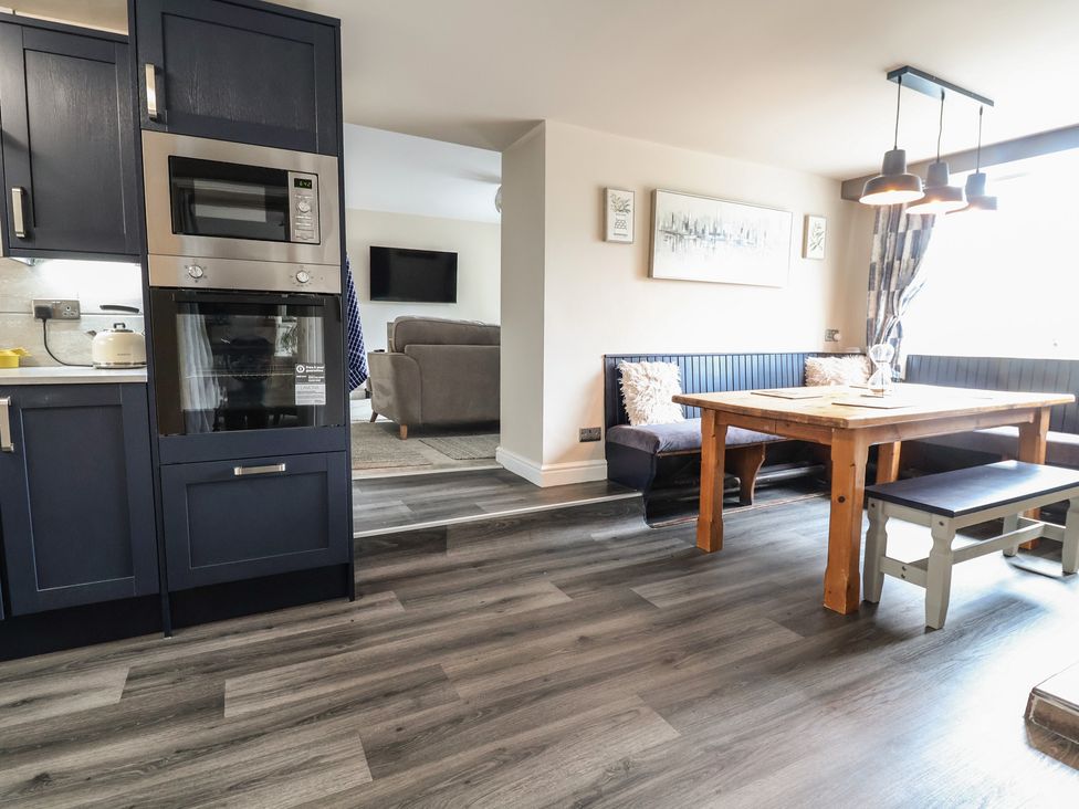 A kitchen and dining area with appliances and seating at The Old Shady Oak Cottage High Peak