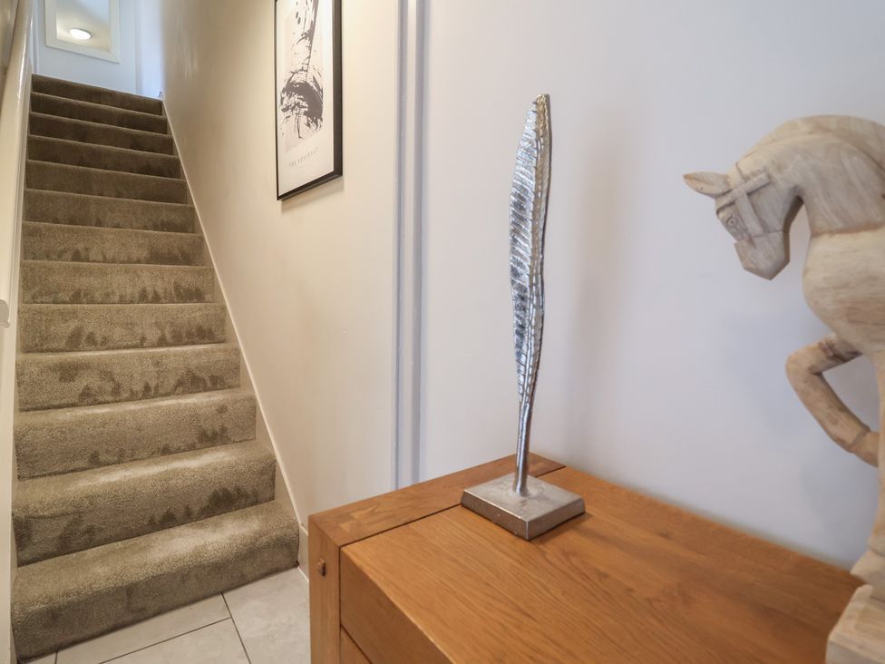 A hallway with stairs and decorative items at The Old Shady Oak Cottage in High Peak