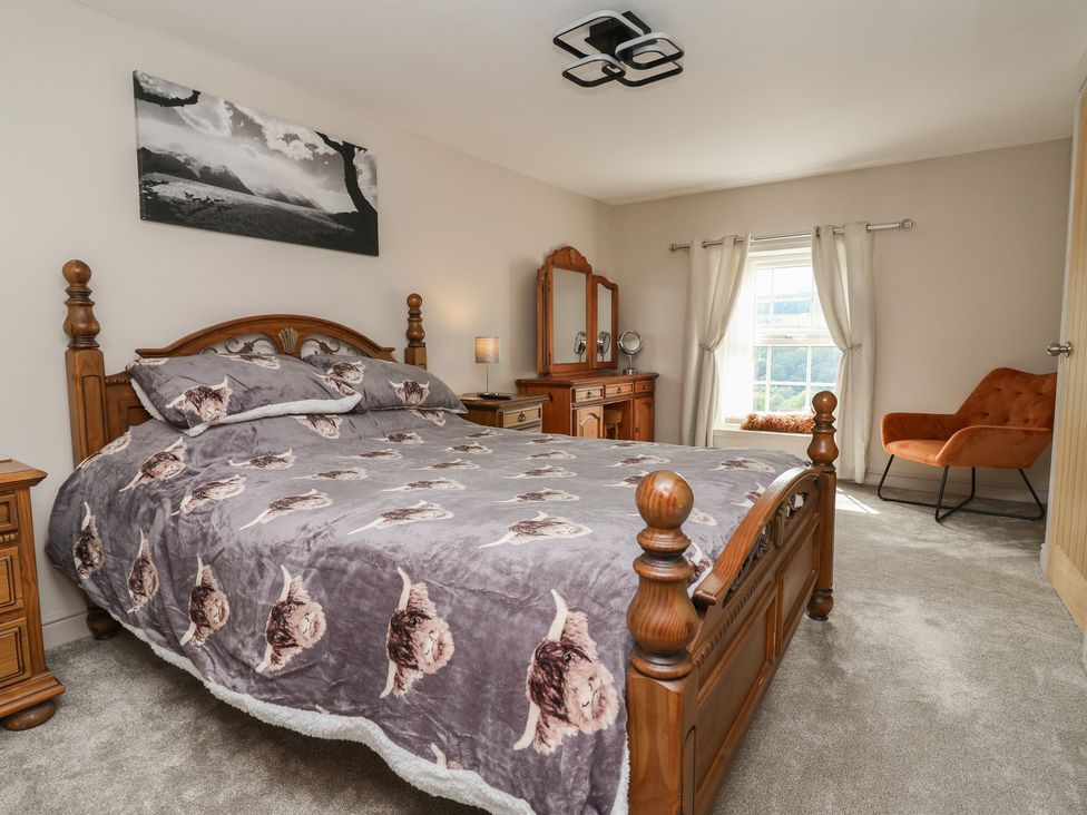 A bedroom with a bed and dresser at The Old Shady Oak Cottage in High Peak