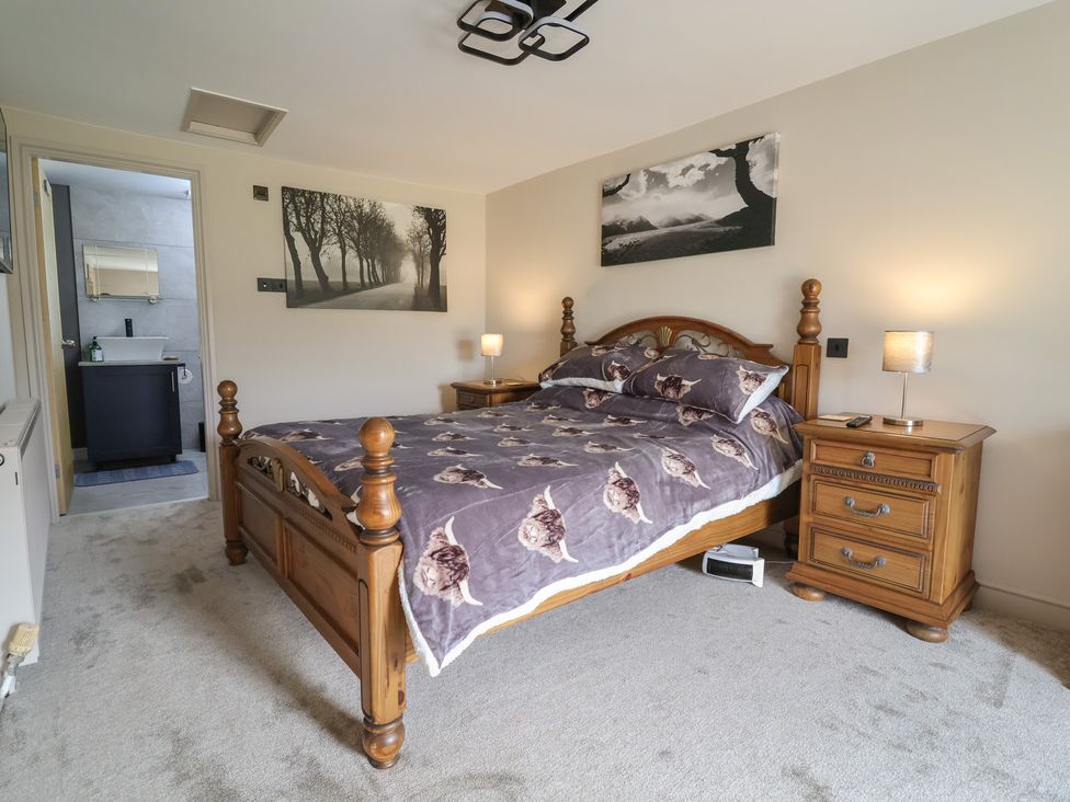 A bedroom with a bed and bedside tables at The Old Shady Oak Cottage in High Peak