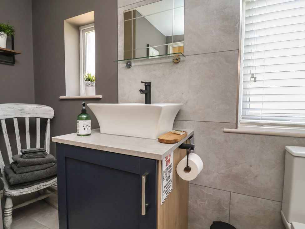 A bathroom with a sink and mirror at The Old Shady Oak Cottage in High Peak